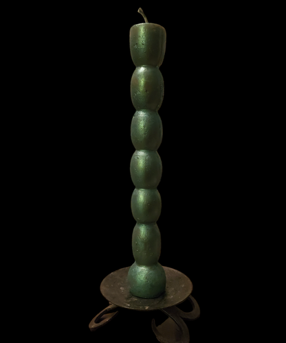 Handcrafted green 7 knob candle, 10 inches tall and 1 inch across, featuring seven knobs or sections for each of 7 days, ideal for manifestation and spellcraft